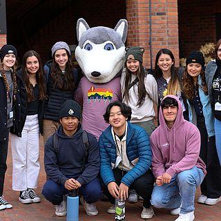 A group of students pose for a photo with WWU mascot Wally Wolf.
